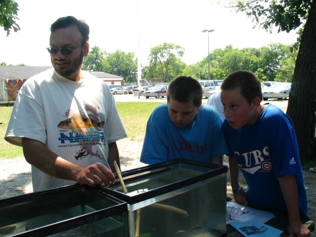 Sajjad Lateef showing fish from Salt Creek to children