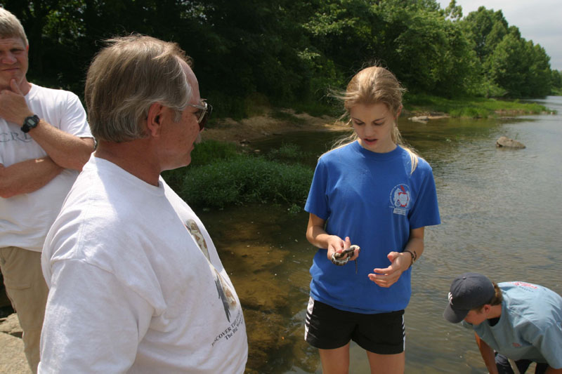 Ken Shirley looks at water snake caught by Heather Smith