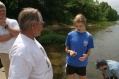 Ken Shirley looks at water snake caught by Heather Smith
